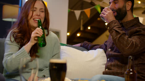 Relaxed-Group-Of-Friends-Sitting-On-Sofa-At-Home-Or-In-Bar-Celebrating-St-Patrick's-Day-With-Party-Drinking-Alcohol-2